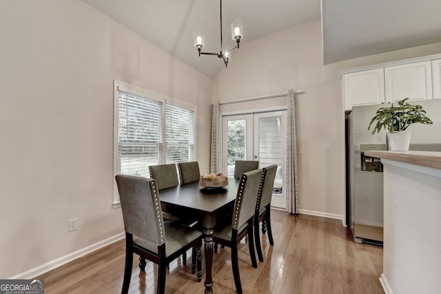 1635 Lake Heights Cir, Dacula, GA 30019 - dining space with a chandelier, light wood-style floors, french doors, and high vaulted ceiling
