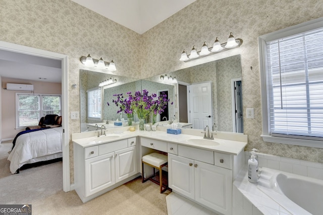 1635 Lake Heights Cir, Dacula, GA 30019 - ensuite bathroom featuring wallpapered walls, double vanity, a garden tub, and a wall mounted air conditioner