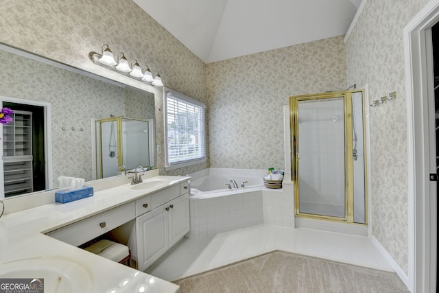 1635 Lake Heights Cir, Dacula, GA 30019 - bathroom with double vanity, a bath, a stall shower, wallpapered walls, and vaulted ceiling