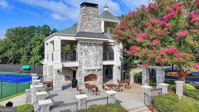 1635 Lake Heights Cir, Dacula, GA 30019 - view of property's community with a tennis court and a patio