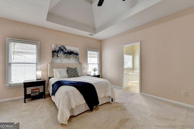 1635 Lake Heights Cir, Dacula, GA 30019 - bedroom with light carpet, ensuite bathroom, a raised ceiling, and a ceiling fan