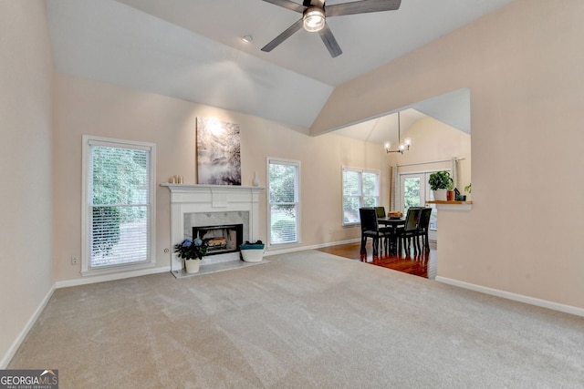 1635 Lake Heights Cir, Dacula, GA 30019 - living room featuring carpet, a chandelier, a premium fireplace, a ceiling fan, and vaulted ceiling