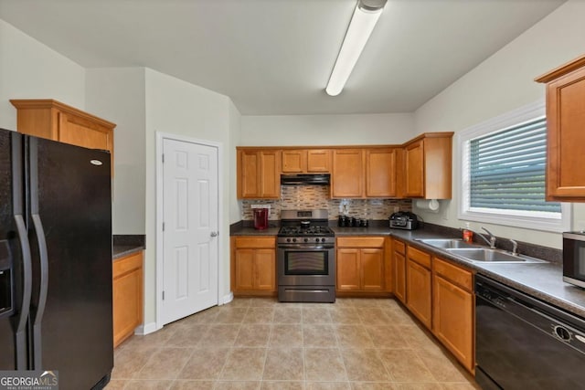 1936 Lakeshore Overlook Cir NW, Kennesaw, GA 30152 - kitchen with black appliances, under cabinet range hood, dark countertops, and brown cabinets