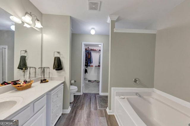 1936 Lakeshore Overlook Cir NW, Kennesaw, GA 30152 - full bathroom featuring a garden tub, vanity, wood finished floors, and a walk in closet