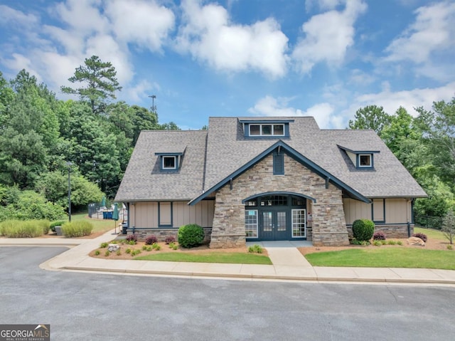 1936 Lakeshore Overlook Cir NW, Kennesaw, GA 30152 - view of front facade featuring french doors, stone siding, a shingled roof, and board and batten siding