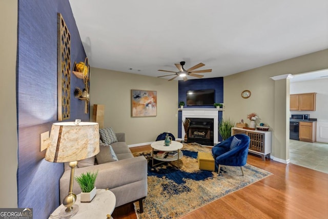 1936 Lakeshore Overlook Cir NW, Kennesaw, GA 30152 - living area featuring ceiling fan, a glass covered fireplace, and wood finished floors
