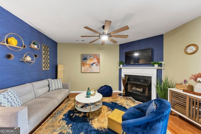 1936 Lakeshore Overlook Cir NW, Kennesaw, GA 30152 - living area with an accent wall, a ceiling fan, a fireplace, and wood finished floors