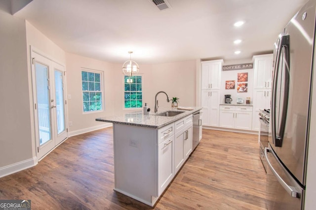 909 Shiloh Ridge Run NW, Kennesaw, GA 30144 - kitchen featuring appliances with stainless steel finishes, white cabinets, light wood-style flooring, and recessed lighting