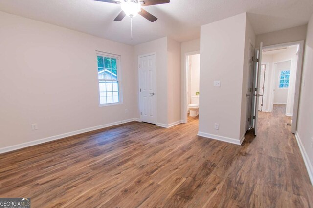 909 Shiloh Ridge Run NW, Kennesaw, GA 30144 - unfurnished bedroom with wood finished floors, ceiling fan, and ensuite bathroom