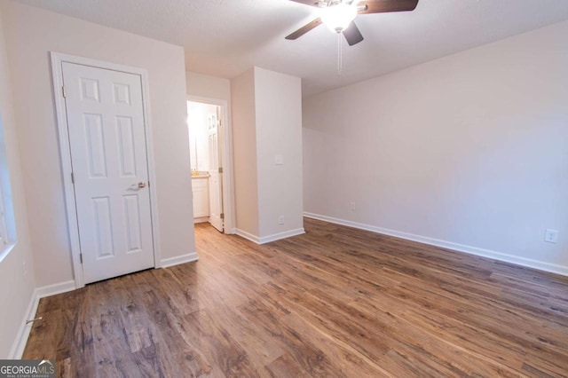909 Shiloh Ridge Run NW, Kennesaw, GA 30144 - unfurnished bedroom featuring wood finished floors, connected bathroom, and a ceiling fan