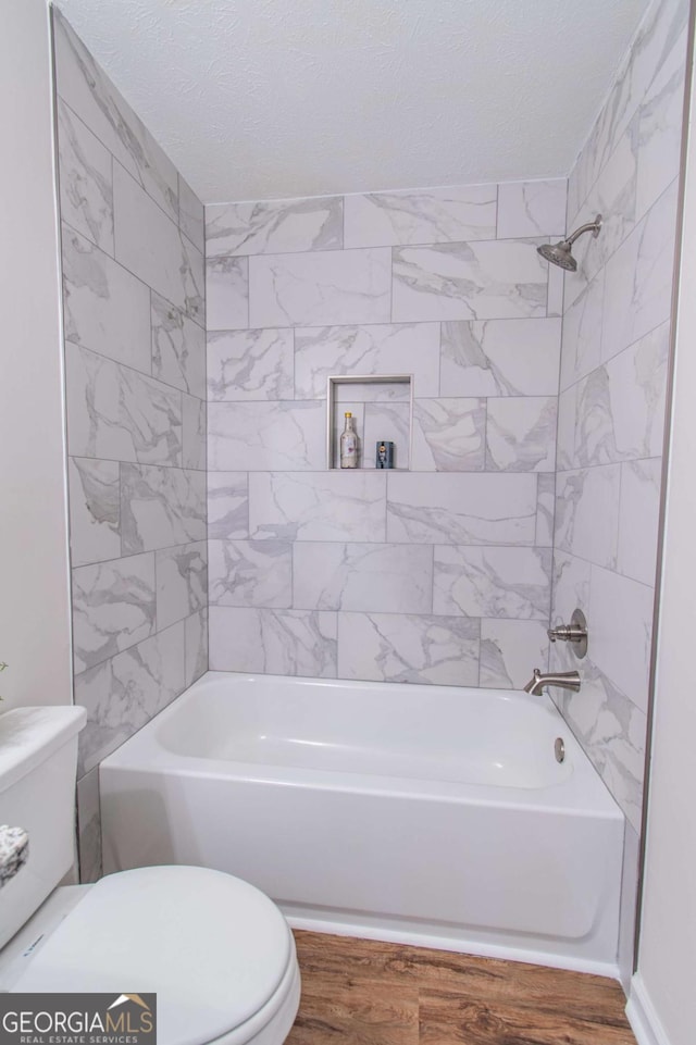 909 Shiloh Ridge Run NW, Kennesaw, GA 30144 - bathroom with washtub / shower combination, wood finished floors, and a textured ceiling