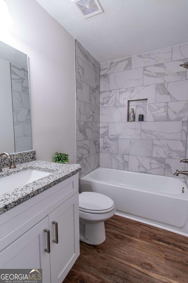 909 Shiloh Ridge Run NW, Kennesaw, GA 30144 - full bath featuring vanity, wood finished floors, shower / tub combination, and a textured ceiling