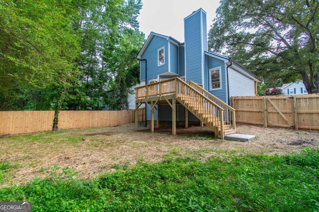 909 Shiloh Ridge Run NW, Kennesaw, GA 30144 - rear view of house featuring stairs, a chimney, a fenced backyard, and a deck