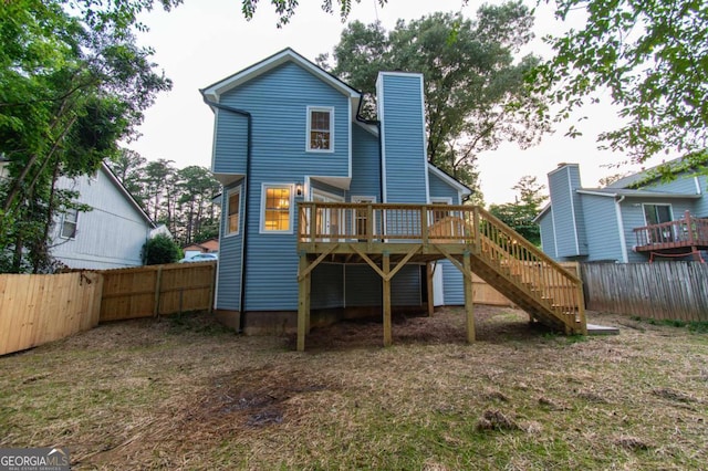 909 Shiloh Ridge Run NW, Kennesaw, GA 30144 - back of house with stairway, a deck, a fenced backyard, and a chimney