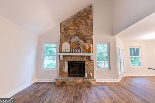 909 Shiloh Ridge Run NW, Kennesaw, GA 30144 - unfurnished living room featuring wood finished floors, a fireplace, and high vaulted ceiling