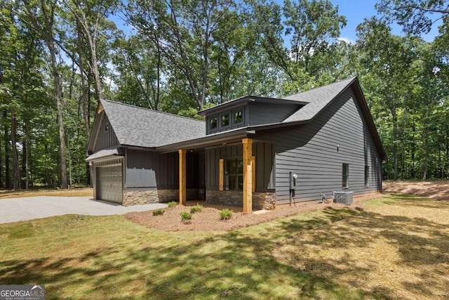 1687 Harmony Rd, Temple, GA 30179 - view of front of property with a shingled roof, a garage, stone siding, board and batten siding, and driveway