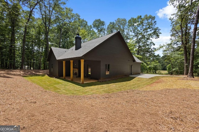 1687 Harmony Rd, Temple, GA 30179 - view of home's exterior featuring a patio, a chimney, and a yard