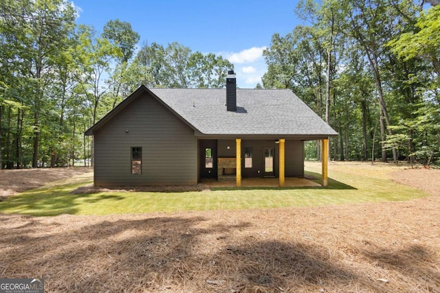 1687 Harmony Rd, Temple, GA 30179 - back of property with a chimney, a shingled roof, and a lawn