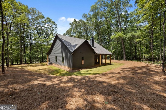 1687 Harmony Rd, Temple, GA 30179 - view of side of home featuring a chimney and a shingled roof