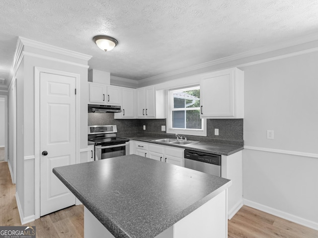 4720 Hull Rd SE, Conyers, GA 30094 - kitchen featuring appliances with stainless steel finishes, under cabinet range hood, dark countertops, white cabinetry, and light wood-style flooring