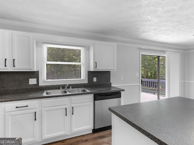 4720 Hull Rd SE, Conyers, GA 30094 - kitchen featuring stainless steel dishwasher, dark countertops, white cabinets, a textured ceiling, and tasteful backsplash