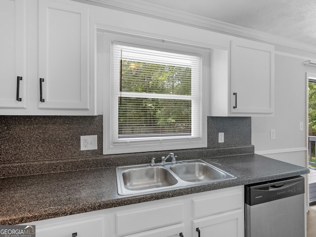 4720 Hull Rd SE, Conyers, GA 30094 - kitchen featuring stainless steel dishwasher, white cabinets, ornamental molding, tasteful backsplash, and dark countertops
