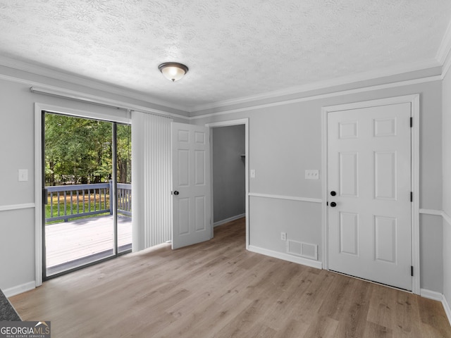 4720 Hull Rd SE, Conyers, GA 30094 - unfurnished living room featuring wood finished floors, a textured ceiling, and ornamental molding