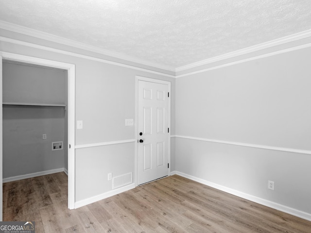 4720 Hull Rd SE, Conyers, GA 30094 - entryway with wood finished floors, a textured ceiling, and crown molding