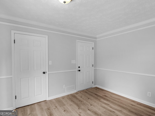 4720 Hull Rd SE, Conyers, GA 30094 - entryway featuring wood finished floors, a textured ceiling, and crown molding