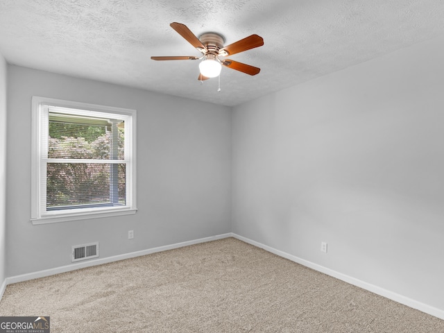 4720 Hull Rd SE, Conyers, GA 30094 - spare room featuring carpet flooring, a textured ceiling, and ceiling fan