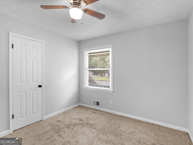 4720 Hull Rd SE, Conyers, GA 30094 - spare room with carpet floors, ceiling fan, and a textured ceiling