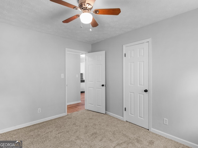 4720 Hull Rd SE, Conyers, GA 30094 - unfurnished bedroom featuring carpet flooring, a textured ceiling, and a ceiling fan