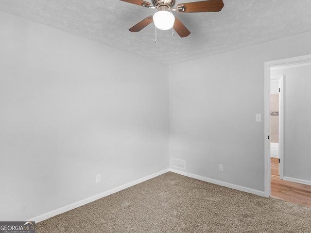 4720 Hull Rd SE, Conyers, GA 30094 - carpeted spare room with a textured ceiling and ceiling fan