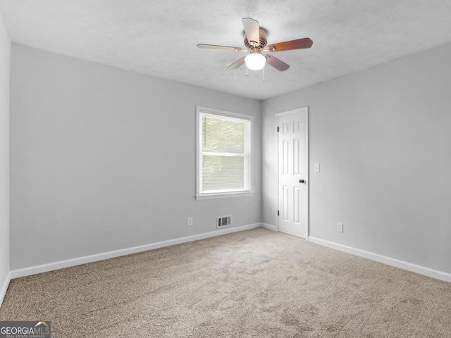 4720 Hull Rd SE, Conyers, GA 30094 - spare room with ceiling fan, a textured ceiling, and carpet