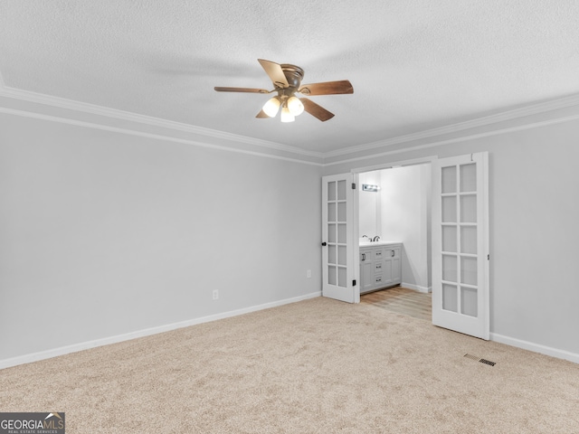 4720 Hull Rd SE, Conyers, GA 30094 - unfurnished bedroom with french doors, a textured ceiling, ornamental molding, light colored carpet, and a ceiling fan