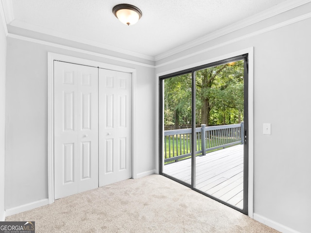 4720 Hull Rd SE, Conyers, GA 30094 - unfurnished bedroom featuring access to exterior, ornamental molding, carpet, and a closet
