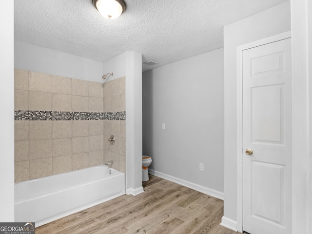4720 Hull Rd SE, Conyers, GA 30094 - full bathroom featuring shower / washtub combination, wood finished floors, and a textured ceiling