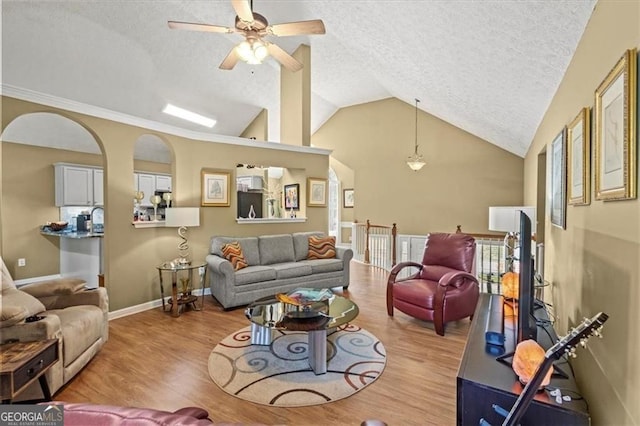 47 Powder Springs St, Hiram, GA 30141 - living room featuring a textured ceiling, wood finished floors, vaulted ceiling, and ceiling fan