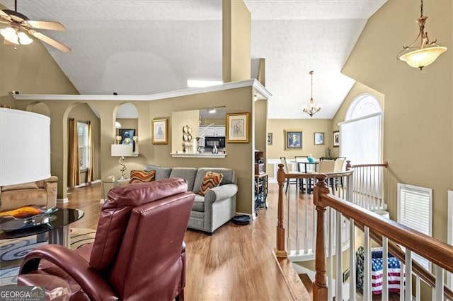 47 Powder Springs St, Hiram, GA 30141 - living room featuring wood finished floors, a textured ceiling, a chandelier, a ceiling fan, and high vaulted ceiling