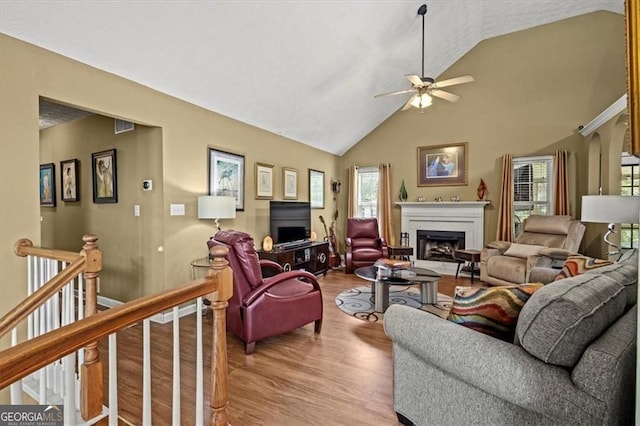 47 Powder Springs St, Hiram, GA 30141 - living area featuring wood finished floors, a ceiling fan, a fireplace, and high vaulted ceiling
