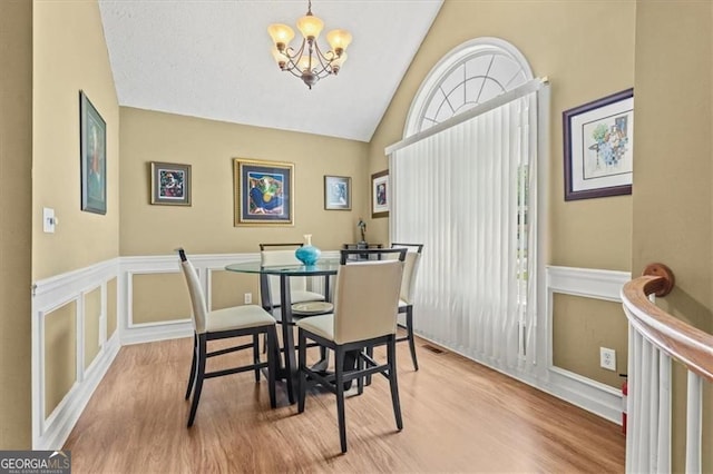 47 Powder Springs St, Hiram, GA 30141 - dining area with wood finished floors, a chandelier, and lofted ceiling