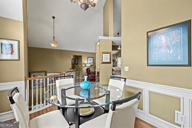 47 Powder Springs St, Hiram, GA 30141 - dining space with a decorative wall, a wainscoted wall, wood finished floors, and lofted ceiling