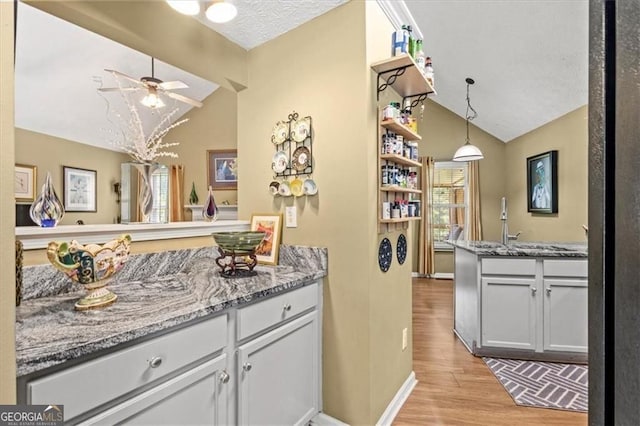 47 Powder Springs St, Hiram, GA 30141 - bar area with vaulted ceiling, a ceiling fan, light wood-type flooring, and pendant lighting
