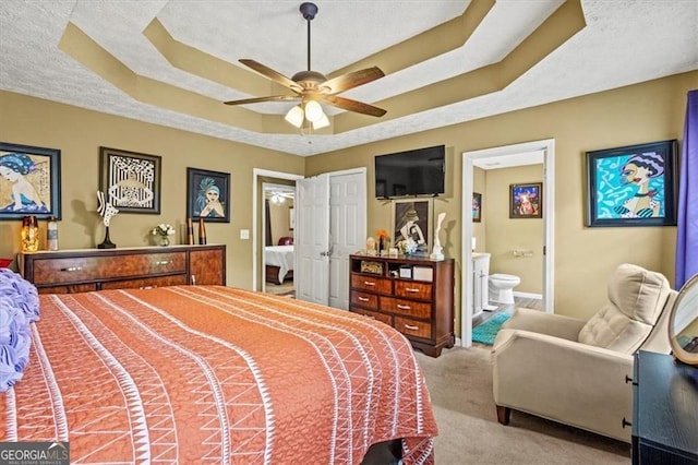 47 Powder Springs St, Hiram, GA 30141 - carpeted bedroom featuring a raised ceiling, ensuite bath, a textured ceiling, and ceiling fan