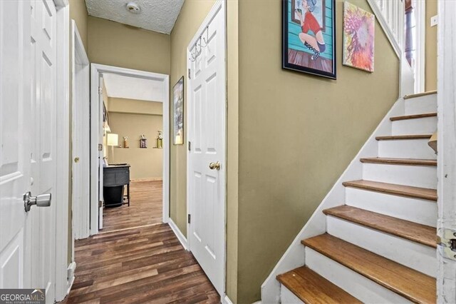 47 Powder Springs St, Hiram, GA 30141 - stairway featuring wood finished floors and a textured ceiling