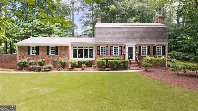 2179 Mountclaire Ct, Stone Mountain, GA 30087 - view of front of house featuring a chimney, a front yard, and brick siding