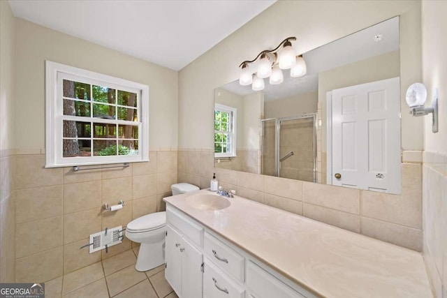 2179 Mountclaire Ct, Stone Mountain, GA 30087 - bathroom featuring tile walls, tile patterned flooring, a stall shower, vanity, and wainscoting