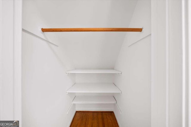 2179 Mountclaire Ct, Stone Mountain, GA 30087 - spacious closet featuring dark wood-style flooring and lofted ceiling