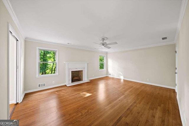 2179 Mountclaire Ct, Stone Mountain, GA 30087 - unfurnished living room featuring plenty of natural light, ornamental molding, wood finished floors, ceiling fan, and a fireplace
