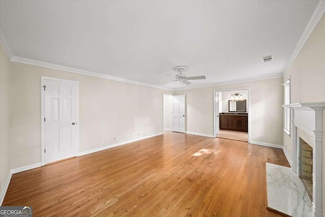 2179 Mountclaire Ct, Stone Mountain, GA 30087 - unfurnished living room featuring a ceiling fan, light wood-style floors, crown molding, and a high end fireplace
